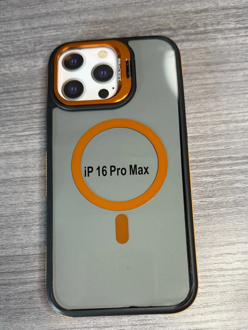Transparent iPhone 16 Pro Max case, orange and black, MagSafe compatible.